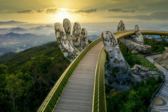 The Golden Bridge held up by giant stone hands at Ba Na Hills